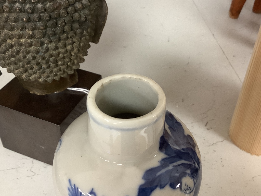 A Thai or Burmese bronze Buddha’s head, with stand 20.5cm and a 19th century Chinese blue and white vase, 12.5cm